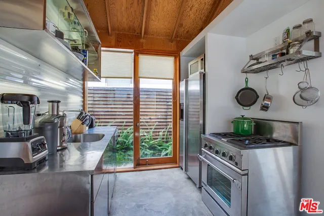 a kitchen with stainless steel appliances granite countertop a stove and a sink