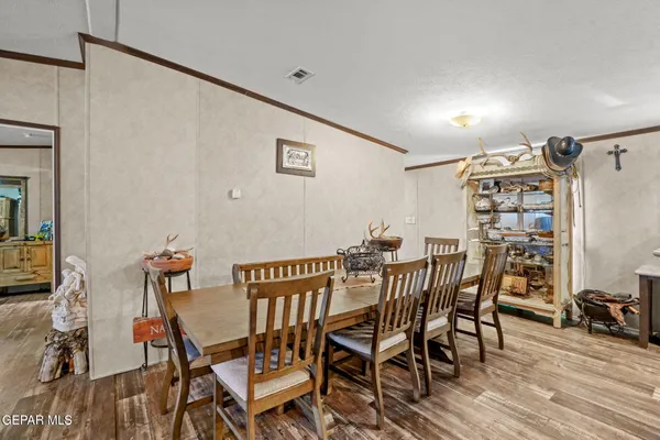a view of a dining room with furniture and wooden floor