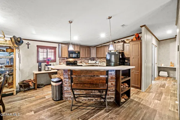 a kitchen with a sink appliances and cabinets
