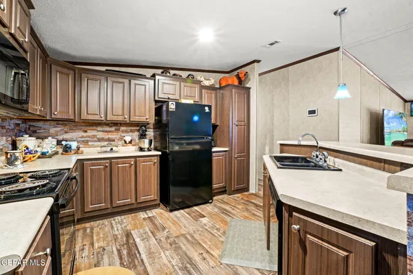 a kitchen with a sink appliances and cabinets