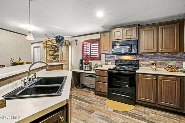 a kitchen with stainless steel appliances a stove sink and cabinets
