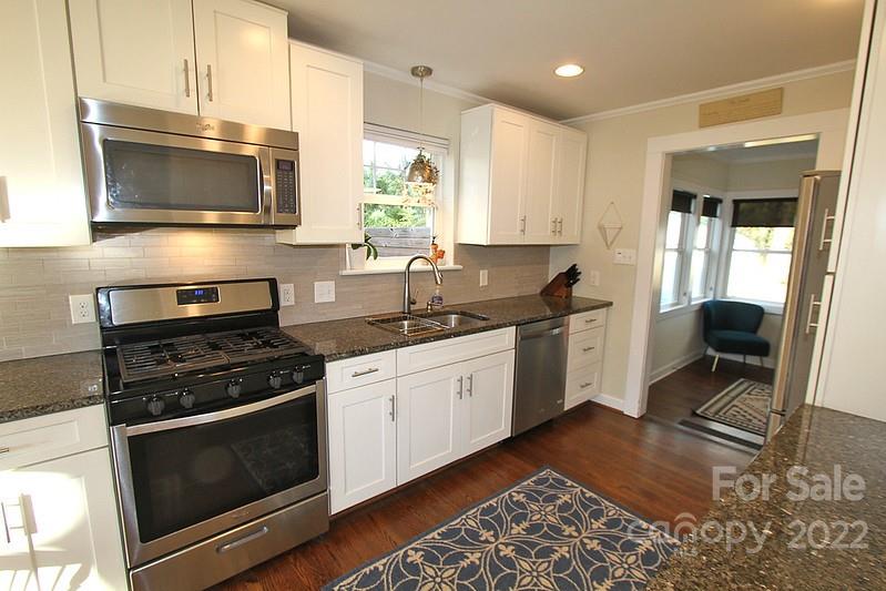 4327 Applegate Road Charlotte, NC 28209 - Photo 11 of 29 a kitchen with a sink stove and microwave