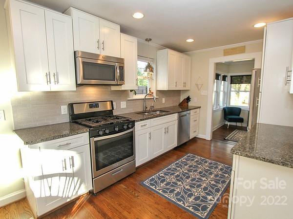 4327 Applegate Road Charlotte, NC 28209 - Photo 12 of 29 a kitchen with stainless steel appliances kitchen island granite countertop a sink and a stove