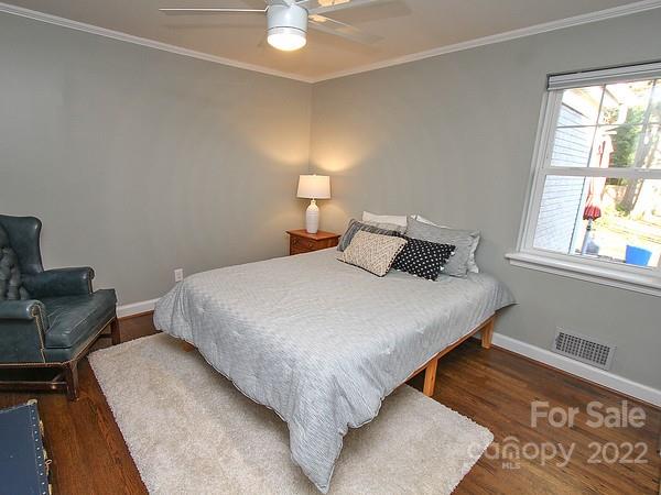 4327 Applegate Road Charlotte, NC 28209 - Photo 15 of 29 a bedroom with a bed and wooden floor