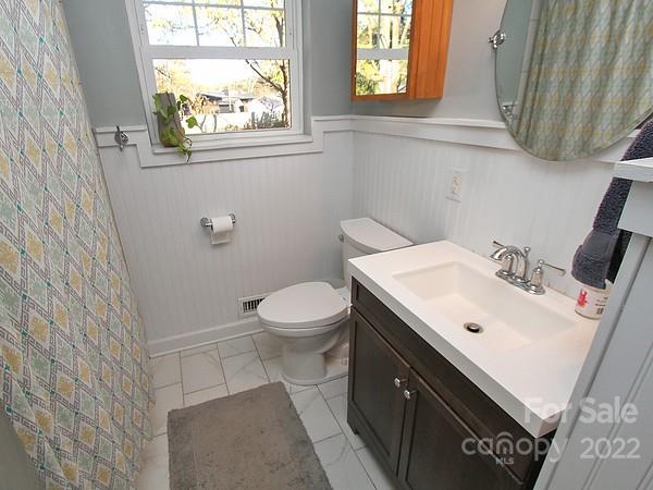 4327 Applegate Road Charlotte, NC 28209 - Photo 16 of 29 a bathroom with a sink a toilet and a window