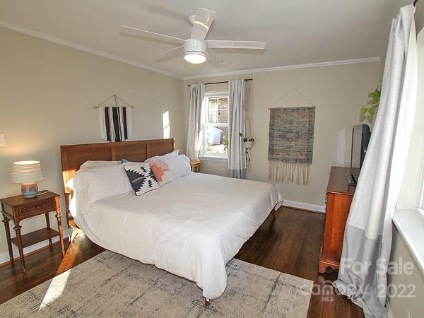 4327 Applegate Road Charlotte, NC 28209 - Photo 19 of 29 a bedroom with a bed and wooden floor
