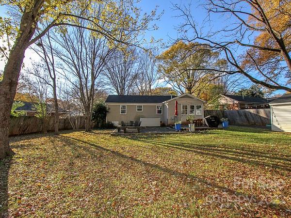 4327 Applegate Road Charlotte, NC 28209 - Photo 26 of 29 a view of a large house with a large tree and a yard