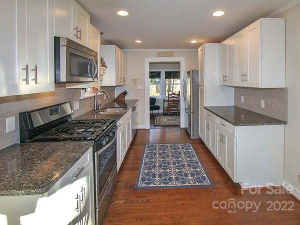 4327 Applegate Road Charlotte, NC 28209 - Photo 10 of 29 a kitchen with stainless steel appliances granite countertop a stove a sink and a microwave