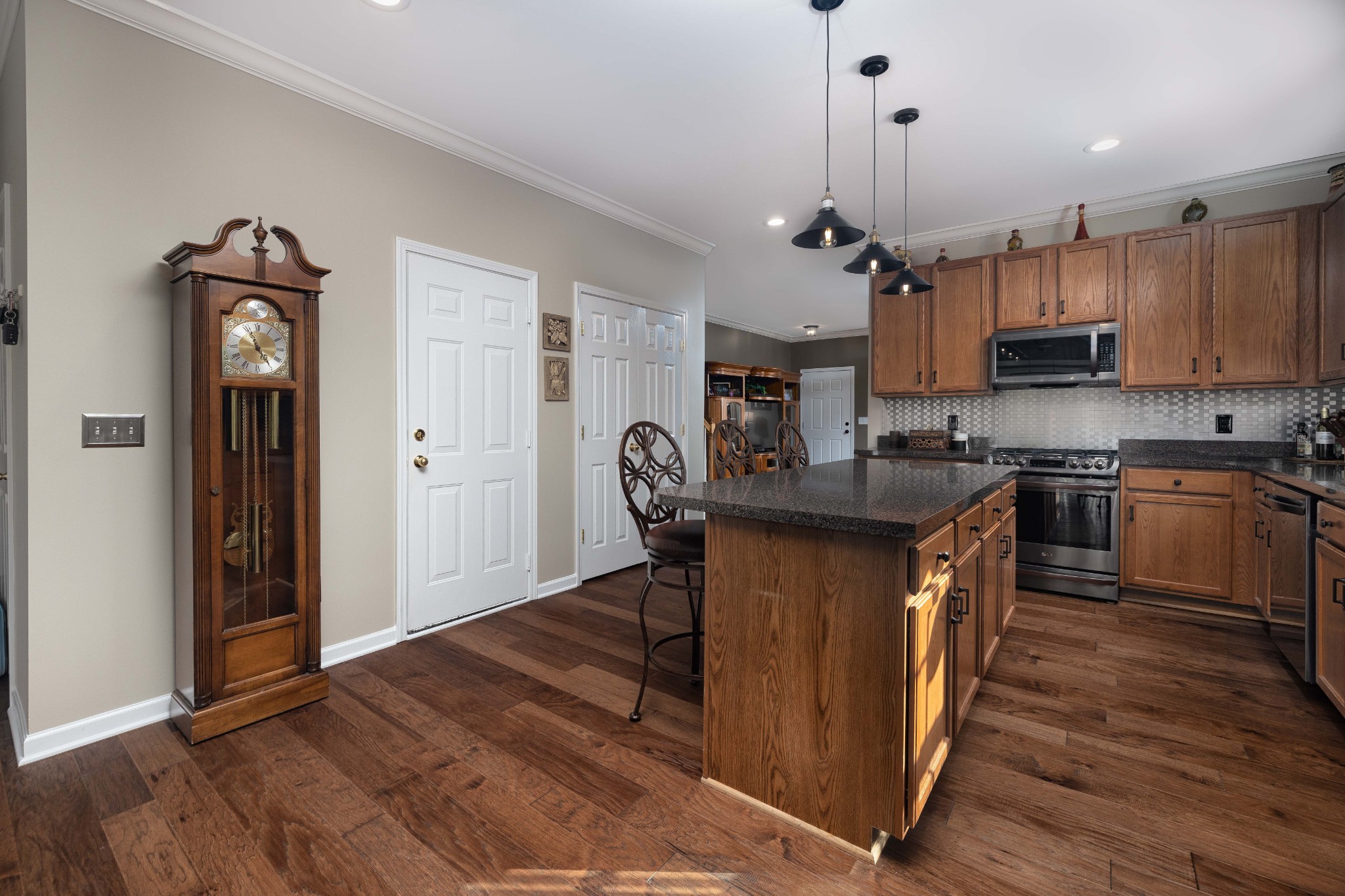2736 McLemore Road Franklin, TN 37064 - Photo 6 of 50 a kitchen with stainless steel appliances granite countertop a refrigerator a sink dishwasher a stove and a dining table with wooden floor