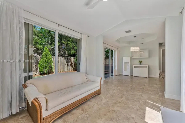 a living room with furniture and large windows