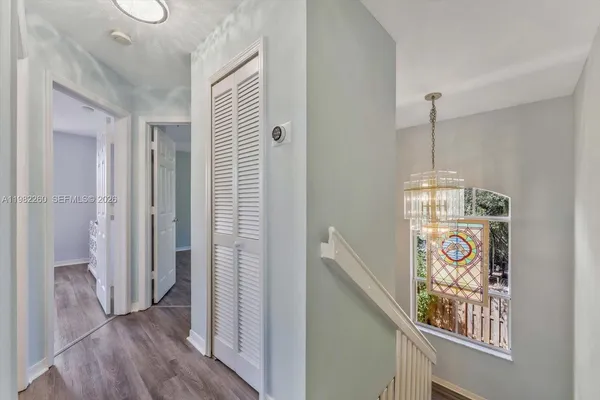 a view of an entryway with wooden floor