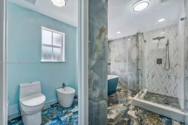 a bathroom with a bathtub and shower
