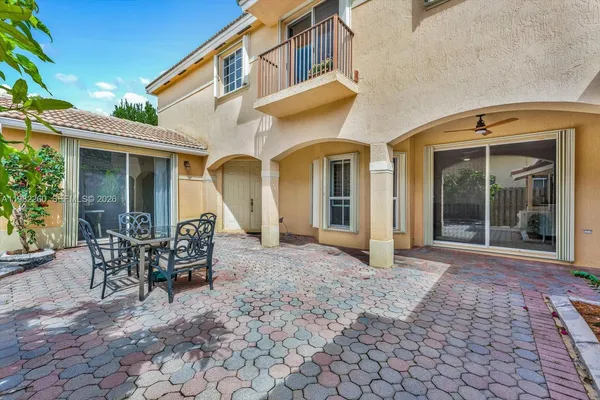 a view of a house with backyard and sitting area