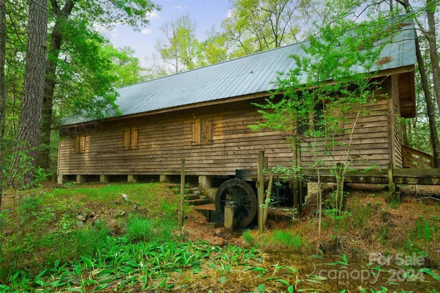 a view of a house with a large window and a yard