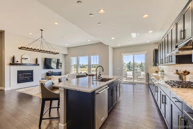 a large kitchen with sink a counter top space and stainless steel appliances