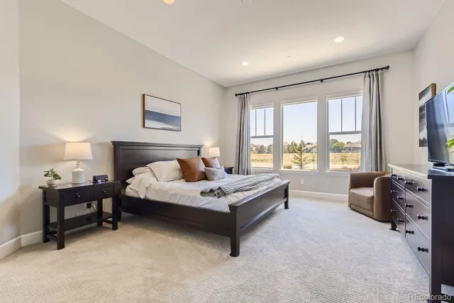 a spacious bedroom with a bed and a couch