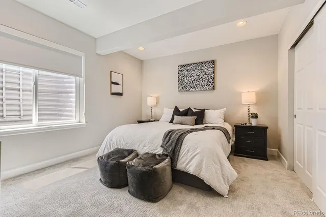 a bedroom with bed and window