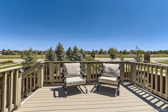 a view of roof deck with two chairs and wooden floor