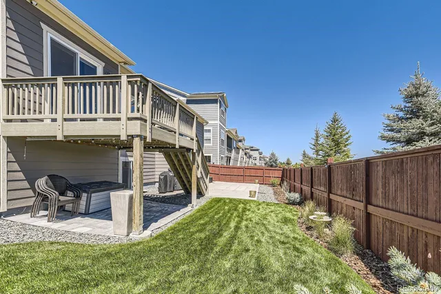 a view of a chair and table in the backyard