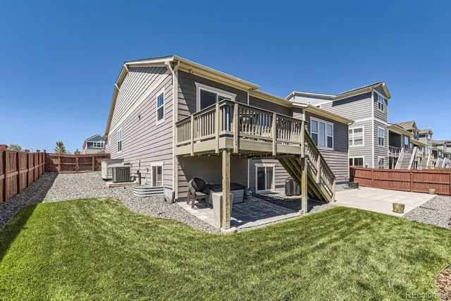 a view of a house with backyard porch and sitting area