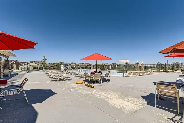 a view of a patio with a table and chairs under an umbrella