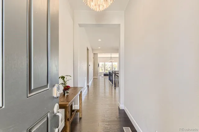a view of a hallway with furniture and a potted plant