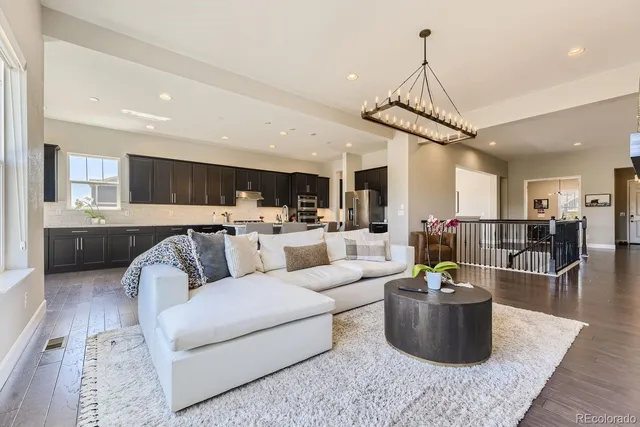 a living room with furniture and kitchen view