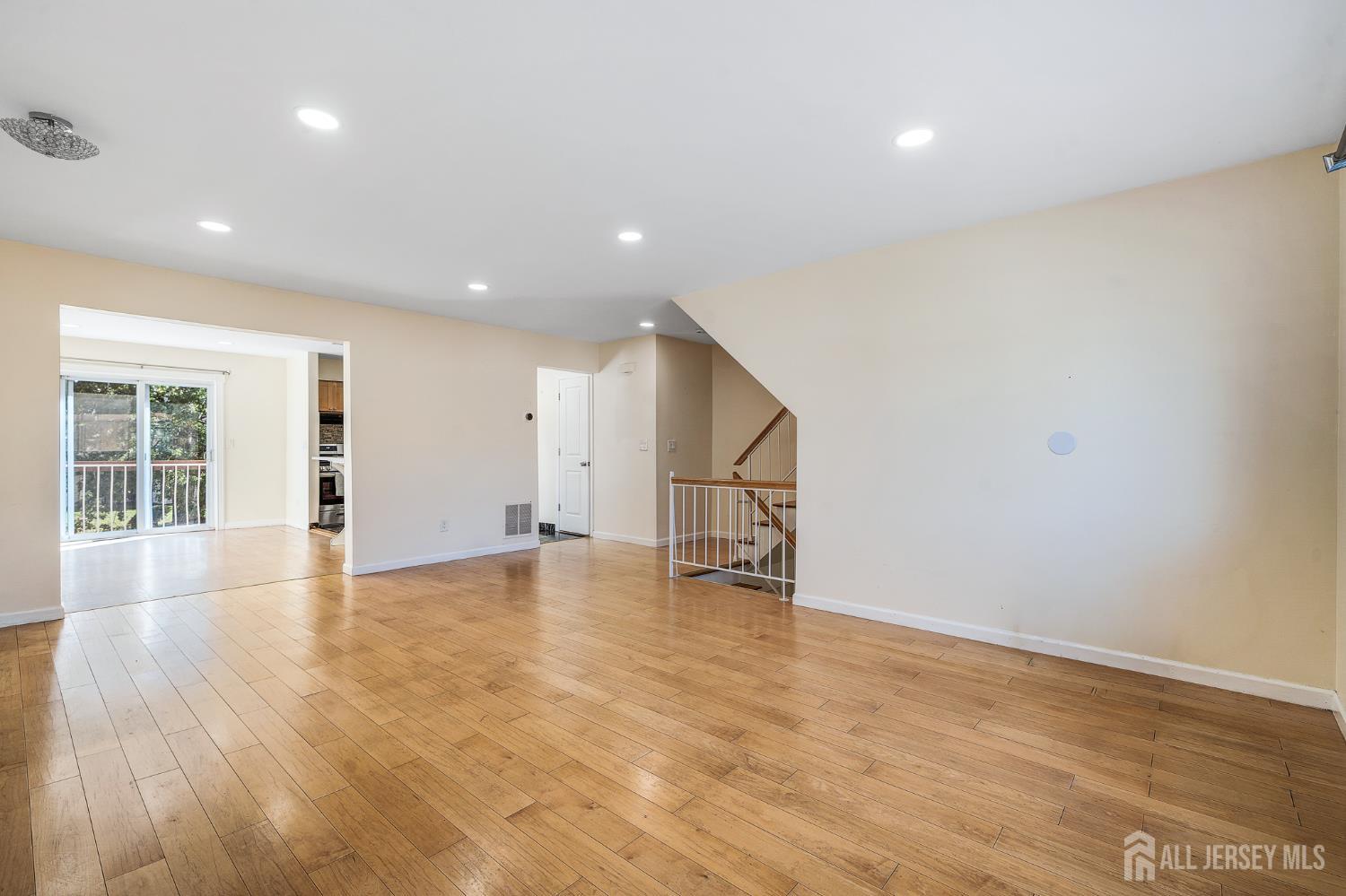 6304 Hana Road Edison, NJ 08817 - Photo 3 of 21 an empty room with wooden floor and windows