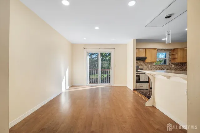 a view of kitchen with sink and refrigerator