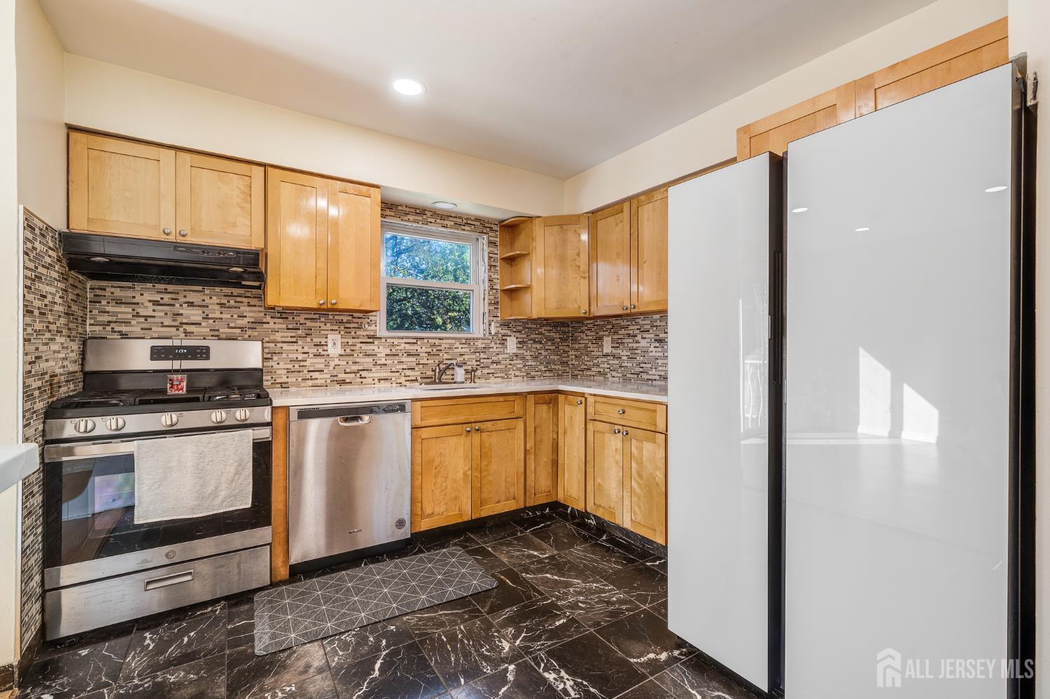 6304 Hana Road Edison, NJ 08817 - Photo 5 of 21 a kitchen with stainless steel appliances granite countertop a stove a sink and a refrigerator