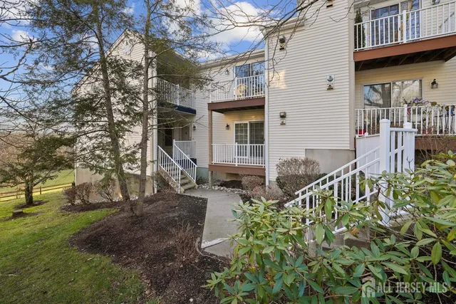 a front view of a house with a tree