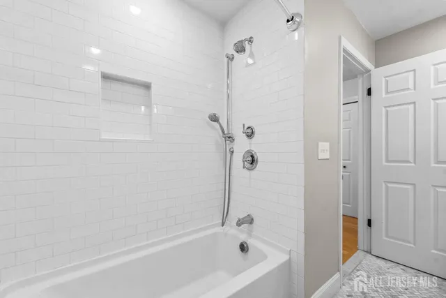 a bathroom with a bathtub and a shower