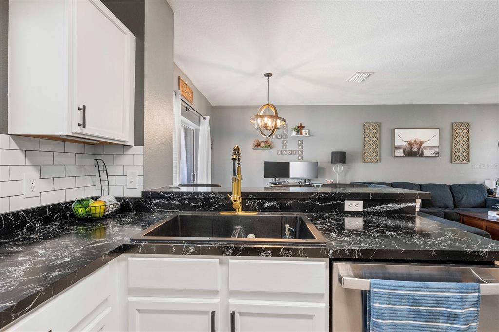 1533 Blue Magnolia Road Brandon, FL 33510 - Photo 16 of 41 a kitchen with a sink stove and cabinets