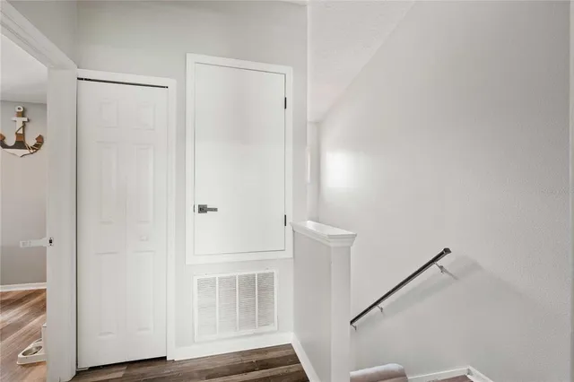 a view of front door with wooden floor