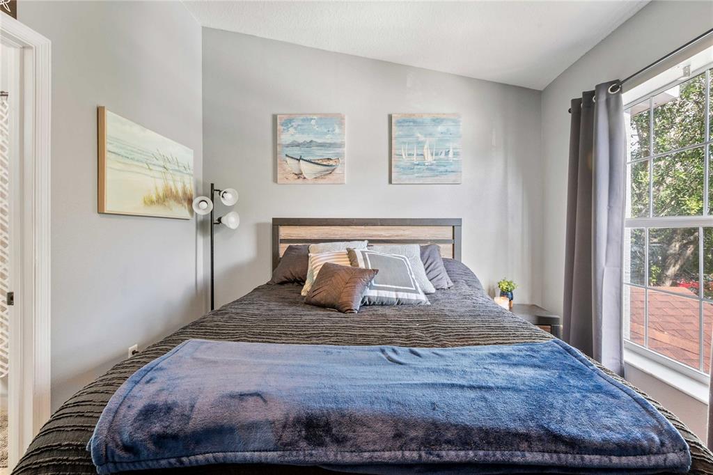 1533 Blue Magnolia Road Brandon, FL 33510 - Photo 22 of 41 a bedroom with a large bed and a window