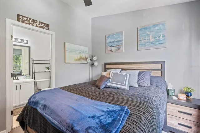 a bedroom with a large bed and a chandelier