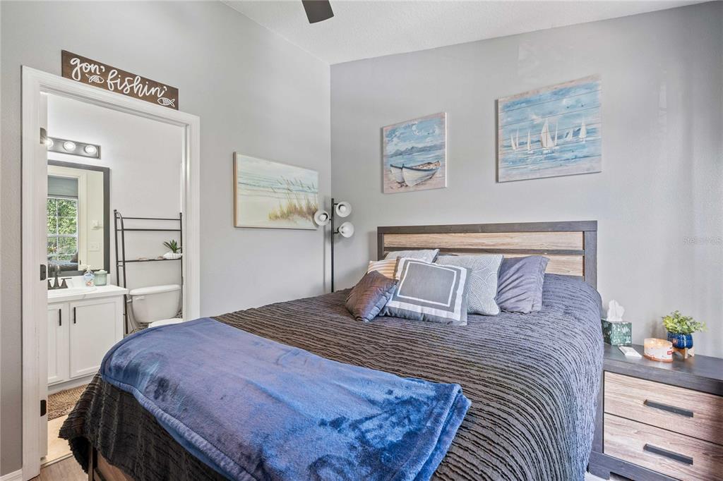 1533 Blue Magnolia Road Brandon, FL 33510 - Photo 23 of 41 a bedroom with a large bed and a chandelier