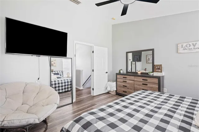 a bedroom with furniture and a flat screen tv