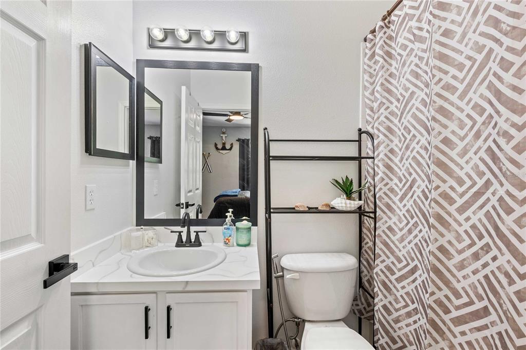 1533 Blue Magnolia Road Brandon, FL 33510 - Photo 29 of 41 a bathroom with a toilet sink and mirror