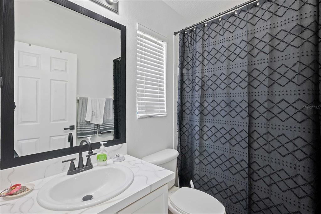 1533 Blue Magnolia Road Brandon, FL 33510 - Photo 30 of 41 a bathroom with a sink toilet and shower