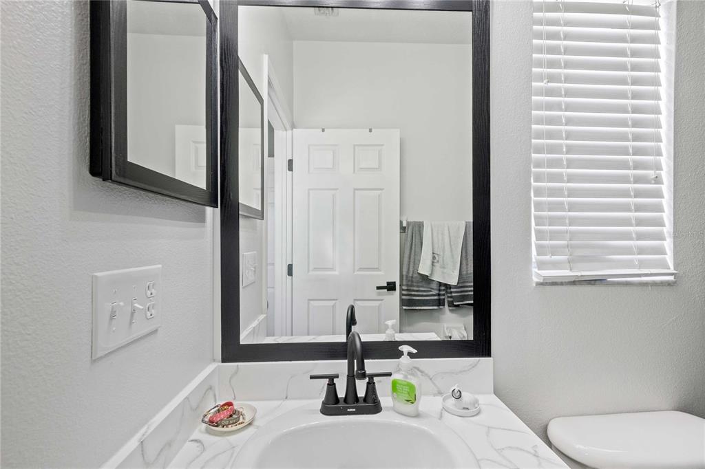 1533 Blue Magnolia Road Brandon, FL 33510 - Photo 31 of 41 a bathroom with a sink and a mirror