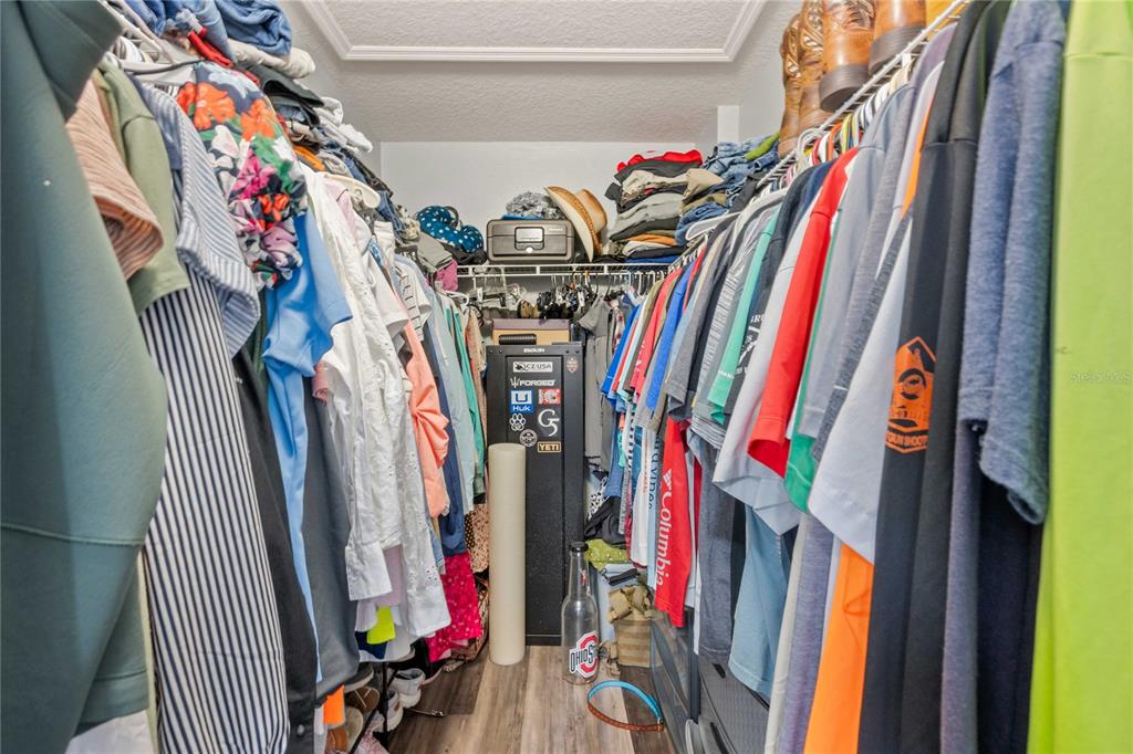 1533 Blue Magnolia Road Brandon, FL 33510 - Photo 35 of 41 a view of walk in closet with clothes