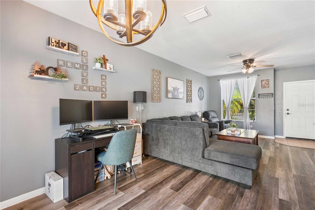 1533 Blue Magnolia Road Brandon, FL 33510 - Photo 5 of 41 a living room with furniture and a flat screen tv