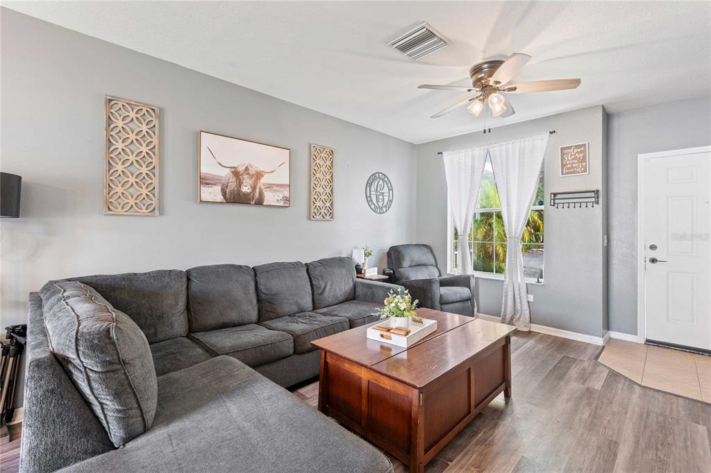 1533 Blue Magnolia Road Brandon, FL 33510 - Photo 6 of 41 a living room with furniture and wooden floor