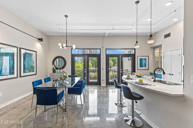a living room with furniture a chandelier and a large window