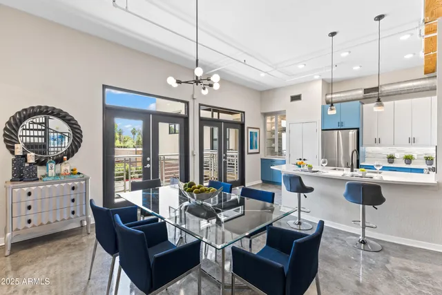 a living room with fireplace furniture and a dining table