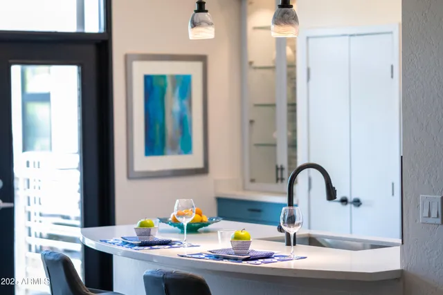 a kitchen with a potted plant on the counter and cabinets