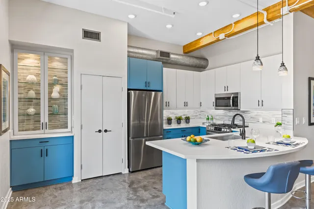 a kitchen with stainless steel appliances a refrigerator sink and cabinets