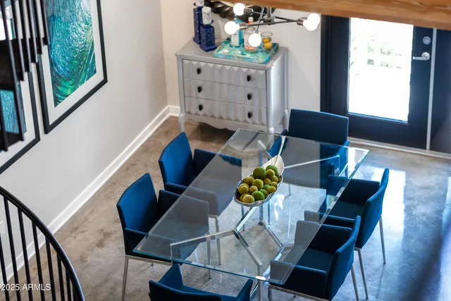 a living room with furniture and a kitchen area