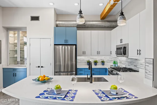 a kitchen with stainless steel appliances granite countertop a sink refrigerator and cabinets